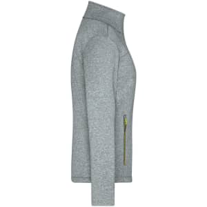 A grey ladies softshell jacket with a high collar and a zippered pocket in a contrasting colour.