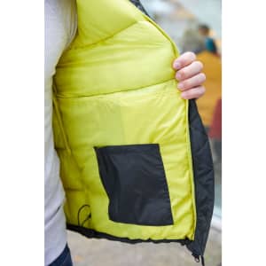A men's padded puffer jacket featuring a black exterior and a bright yellow interior with a side pocket.