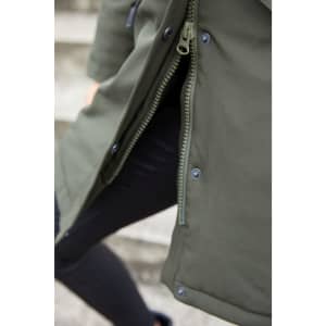 A close-up of a dark green ladies' business parka featuring a zipper and snap buttons. The fabric appears water-resistant.