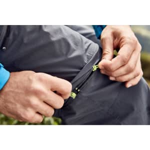 Mens zip-off trekking pants in grey, featuring zippered pockets and adjustable elements for convenience.
