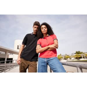 A black and a pink ladies polo shirt worn by a man and a woman outdoors, featuring a logo.