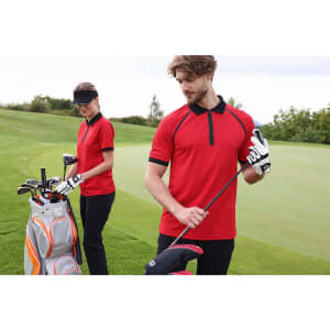 A red men's zip-polo shirt displayed by a man on a golf course, featuring contrasting details, with a golf bag in the background.