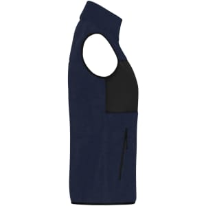 A navy ladies fleece vest featuring a black front panel and a zip pocket. Includes a small logo on the chest.