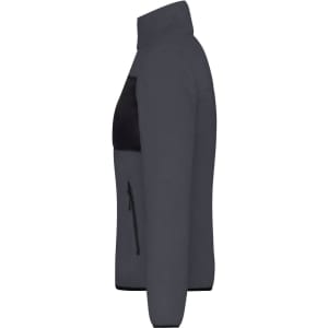 A polar fleece jacket in dark grey with a black panel and zippered pockets. It features a high collar and a fitted design.
