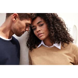 A brown round-neck pullover worn by a model, alongside a model in a navy pullover, both against a neutral background.
