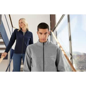 A grey and navy ladies jacket featured on two models, one standing on stairs and the other in front.