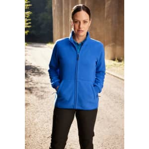 A blue bonded fleece jacket with a zip front and side pockets, worn by a woman in a natural setting.