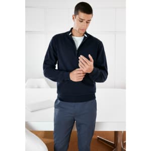 A navy blue men's half-zip jumper with a slim fit, featuring a discreet logo on the front.