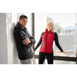 A red Ladies Hybrid Jacket with black sleeves is displayed on a model, alongside a black jacket on another model.