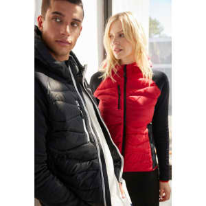 A black and red hybrid jacket worn by a man and a woman, featuring a zip-up design and a logo.