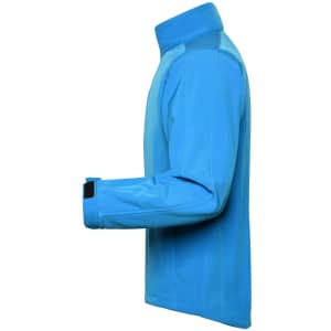 A softshell jacket in a vibrant blue colour featuring a high collar and adjustable cuffs. It has a logo on the sleeve.