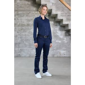 A ladies shirt in navy blue, featuring a button-up design and long sleeves. The model stands against a concrete backdrop.