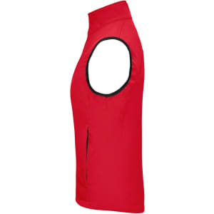 A red ladies softshell vest featuring a sleeveless design and a side zip pocket. It has a logo on it.