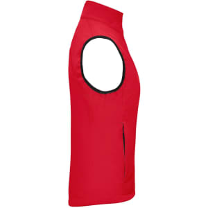 A red ladies softshell vest featuring a sleeveless design and a zipper pocket, with a logo present.