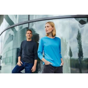 A promotional image featuring a man in a dark shirt and a woman in a blue long-sleeve T-shirt, both standing outdoors.