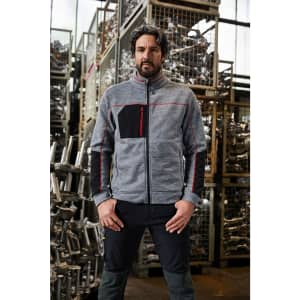 A grey and black polar fleece jacket with a zippered front and a chest pocket, displayed in an industrial setting.