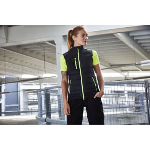 A black vest with neon green accents, featuring a zippered front and pockets. It includes a logo on the fabric.