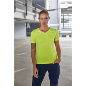 A vibrant yellow ladies work t-shirt, featuring a v-neck design, displayed in an industrial setting.
