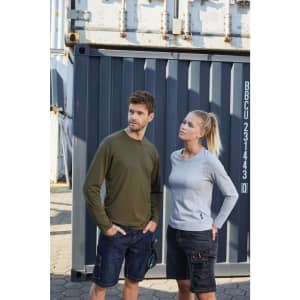 A grey long-sleeve women's work T-shirt is paired with a green long-sleeve men's T-shirt against a shipping container backdrop.