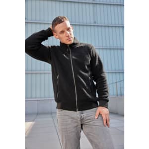 A black Sherpa Jacket with a zip front and side pockets, worn by a person standing against a modern background.