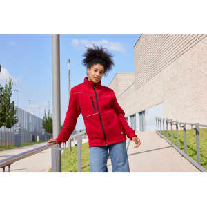 A red fleece jacket with a corduroy look, featuring a branded logo, worn by a model outdoors.