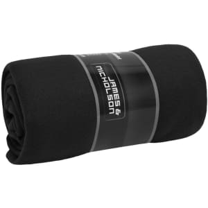 A black fleece blanket rolled and secured with a band, featuring a logo on the band.