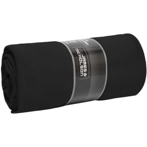 A rolled black fleece blanket with a branded label wrapped around it.