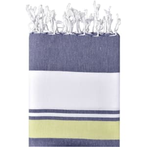 A beach blanket featuring navy blue, white, and lime green stripes with frayed edges. It has a logo.