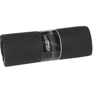 A black picnic blanket rolled up with a branding label attached.
