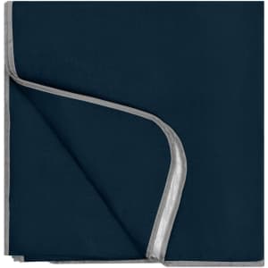 A navy picnic blanket with a light grey trim, neatly folded. The blanket features a logo in one corner.