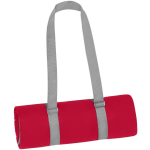 A rolled red picnic blanket secured with grey straps, featuring a simple design and no visible branding.