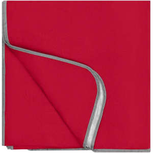 A picnic blanket in vibrant red with a grey edge. It has a soft texture and folded corners.