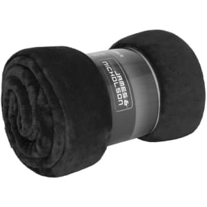 A rolled black microfibre fleece blanket, featuring a simple branding label.