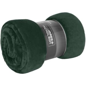 A rolled dark green microfibre fleece blanket, featuring a black branding label.