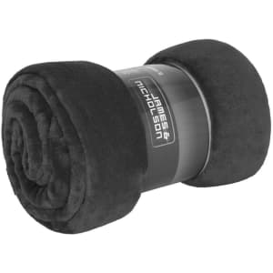 A rolled black microfibre fleece blanket with a branded label.