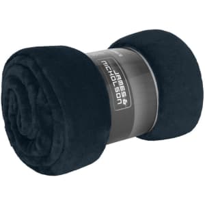 A rolled microfibre fleece blanket in dark navy blue, featuring a branding label.