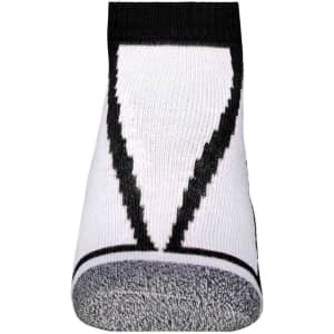 A pair of white sneaker socks with a black pattern and a logo on the cuff.
