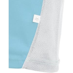 A close-up of a light blue sports shirt with mesh detailing, featuring a small logo.