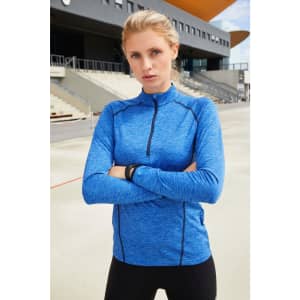 A long-sleeved sports shirt in blue with a zip and fitted design, featuring a logo on the front.