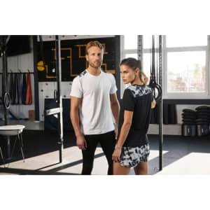 A ladies' sports shirt in black with a patterned back, worn by a model alongside a man in a white t-shirt.