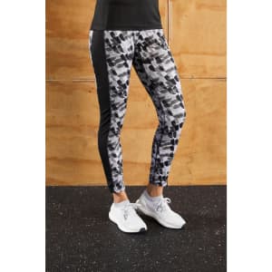 Ladies sports tights in a black and grey abstract print, featuring a fitted design and a logo on the waistband.