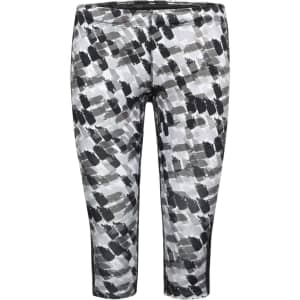 A pair of ladies' 3/4 sports tights featuring a black and grey abstract pattern, with a logo on the waistband.