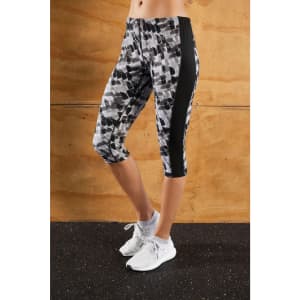 Ladies 3/4 tights in a grey and black abstract pattern with a side black panel and a logo.