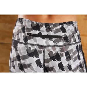 Ladies' 3/4 sports tights in a grey and black abstract pattern, with a back pocket and a logo.