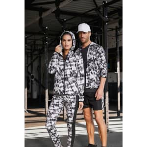 A ladies' soft shell jacket featuring a black and white graphic pattern, accompanied by a male model in matching attire.