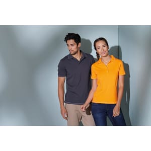 A grey polo shirt and an orange polo shirt are worn by a man and woman standing together in a modern setting.