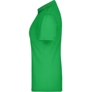 A green ladies active polo shirt featuring a collar and short sleeves, with a logo on the garment.