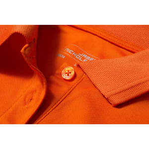 An orange ladies active polo shirt featuring a collar and a button, with a branding label inside.