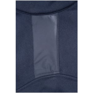 A close-up of a navy blue knitted fleece jacket featuring a smooth, contrasting panel. The jacket has a logo.