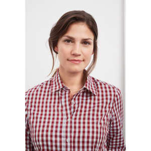 A button-up blouse featuring a red and white checked pattern, worn by a woman with dark hair.